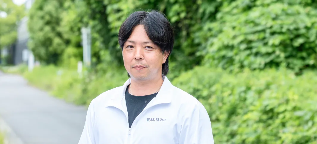 ビートラストの工程管理（塗装）藤原路由の笑顔のポートレート写真。