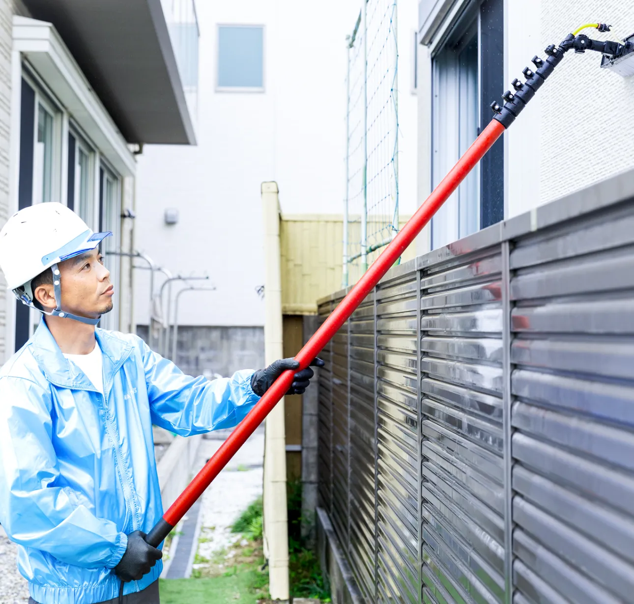 壁面洗浄用ブラシで住宅の外壁洗浄を行い、建物の美観を回復する施工イメージ